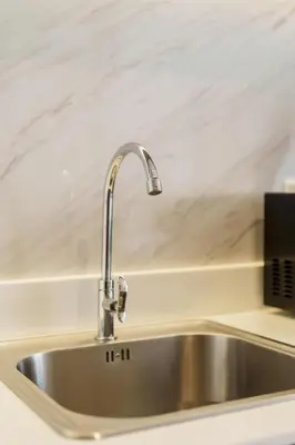 a stainless steel sink in a kitchen at Beachfront 1524 Wyndham Gardens Condo Naithon in Phuket Town