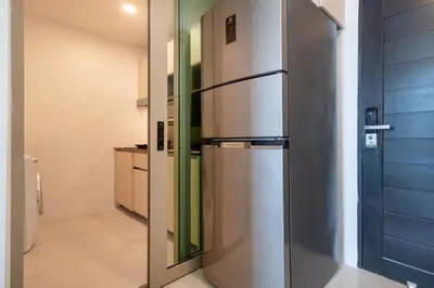 a stainless steel refrigerator in a kitchen at Studio Apt Seaview Balcony - Oceana C63 in Kamala Beach