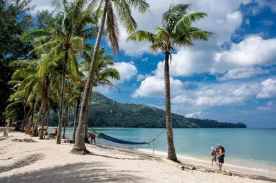 a group of people walking on a beach with palm trees at Studio Apt Seaview Balcony - Oceana C63 in Kamala Beach