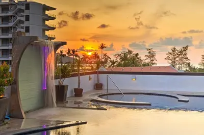 a pool on a building with a sunset in the background at Bangla Jacuzzi Suite 212 in Patong Beach