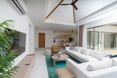 a living room with a white couch and a table at Phang nga Villas Private Pool & Tropical Retreats