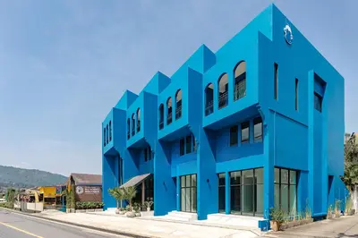 a blue building on the side of a street at Blu Monkey Boutique Naiharn Beach in Nai Harn Beach