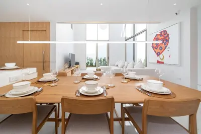a dining room with a wooden table and chairs at Modern and elegant 4-bedroom pool villa suitable for families - V10 in Ban Pak Lak