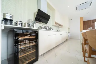 a kitchen with white cabinets and a counter at Modern and elegant 4-bedroom pool villa suitable for families - V10 in Ban Pak Lak