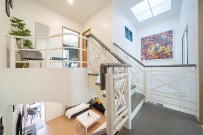 a staircase in a home with white walls at Chill Beach Bangla comfy bed and pool 3 bedrooms 10pax in Patong Beach