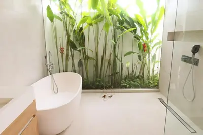 a bathroom with a bath tub and a large aquarium at Phuket luxury Asherah villa Bang Tao in Ban Phru Champa