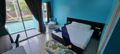 a bedroom with a bed with a blue wall at Bedroom201 Kata Beach Phuket in Kata Beach