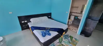 a small bed in a room with a blue at Bedroom201 Kata Beach Phuket in Kata Beach