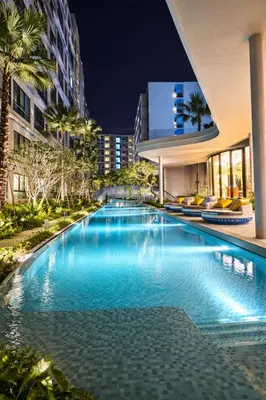a swimming pool in front of a building at night at Work & Travel in Kathu