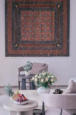 a living room with a rug and a table with flowers at Étoile Kata Luxury Pool Villas by Astra in Kata Beach