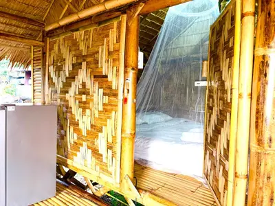 an inside view of a bamboo house with a window at Patong Canal House 2 in Patong Beach