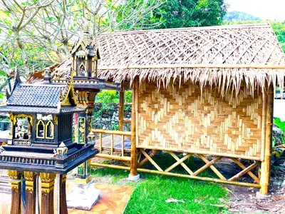 a small hut with a thatched roof on the grass at Patong Canal House 2 in Patong Beach