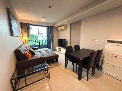 a living room with a couch and a table at 6th Avenue 2 bedroom in Surin Beach