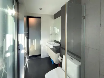 a bathroom with a white sink and a toilet at 6th Avenue 2 bedroom in Surin Beach