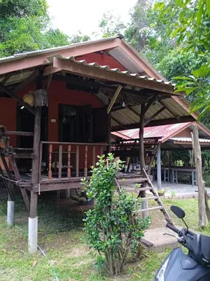 a small red house with a wooden roof at Bang Riss Kee Home Stay3 in Ko Yao Noi