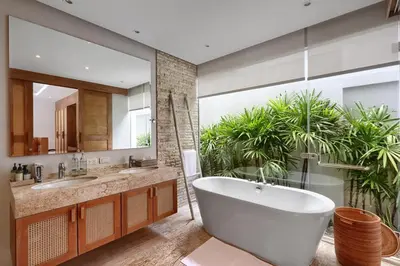 a bathroom with a tub and a large mirror at Botanica Luxury Pool Villa Phuket in Thalang