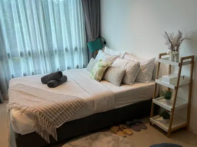 a bed with a teddy bear sitting on top of it at Utopia Central in Ban Ket Ho