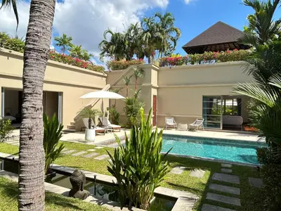 a villa with a swimming pool and palm trees at Luxury Pool Villa Bangtao Phuket close to beach in Bang Tao Beach