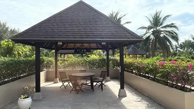 a wooden pavilion with a table and chairs on a patio at Luxury Pool Villa Bangtao Phuket close to beach in Bang Tao Beach