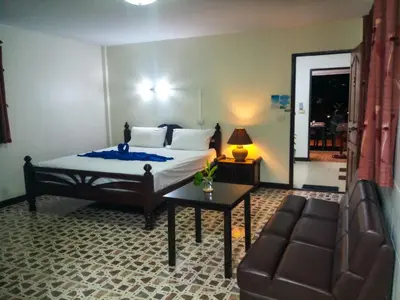 a bedroom with a bed and a couch at Kata Lina rooftop in Kata Beach