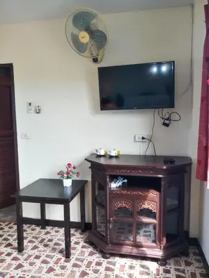 a living room with a fireplace and a flat screen tv at Kata Lina rooftop in Kata Beach