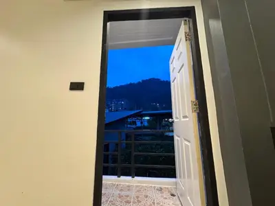 an open door with a view of a balcony at Chapter 26 in Patong Beach