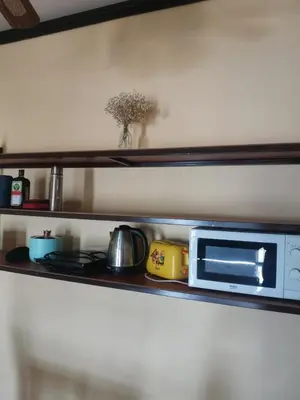 a shelf with a microwave and other items on it at Karon cottage Resort 2 Bedrooms Vl and BBQ in Karon Beach
