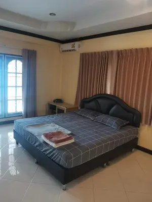 a bedroom with a large bed with a black headboard at Karon cottage Resort 2 Bedrooms Vl and BBQ in Karon Beach
