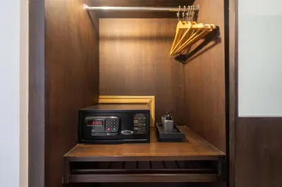 a microwave on a wooden shelf in a kitchen at Private villa at Oxygen Bangtao -pool garden BBQ in Ban Thalat Choeng Thale