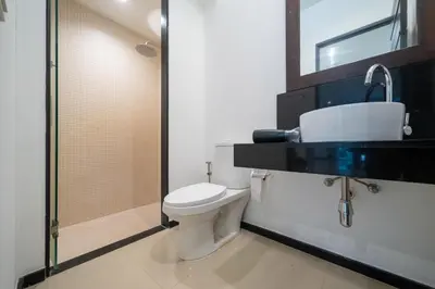 a bathroom with a toilet and a sink and a shower at Private villa at Oxygen Bangtao -pool garden BBQ in Ban Thalat Choeng Thale