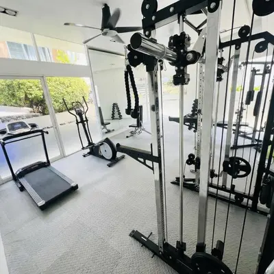a gym with several tread machines and a simulator at Kamala Hills Ocean Breeze 3 Bedroom Loft with Access to 3 Pools in Kamala Beach