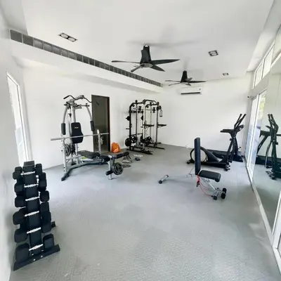 a gym with several treadmills and exercise machines at Kamala Hills Ocean Breeze 3 Bedroom Loft with Access to 3 Pools in Kamala Beach