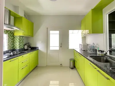 a kitchen with lime green cabinets and a sink at Cozy Serene Home Quiet Garden for a Peaceful Stay in Phuket Town