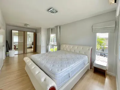 a large bedroom with a white bed and a window at Cozy Serene Home Quiet Garden for a Peaceful Stay in Phuket Town