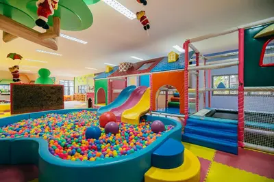 a childrens play room with a pool and a slide at Rawayana West Villas & Kids Park in Rawai Beach