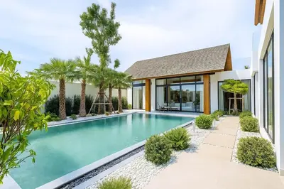 a swimming pool in the backyard of a house at The White Courtyard Sanctuary 4BR Pool Viila in Koh Lone