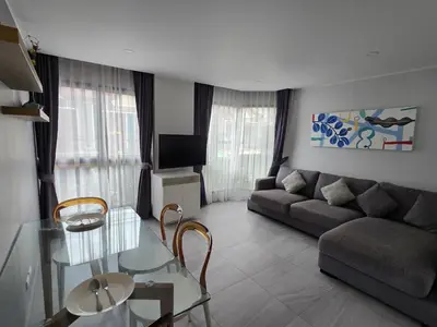 a living room with a couch and a glass table at Urban Chill -1 Bedroom (T2-216) in Phuket Town