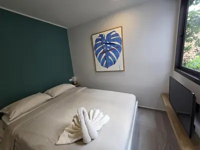 a bedroom with a bed with a towel on it at Urban Chill -1 Bedroom (T2-216) in Phuket Town