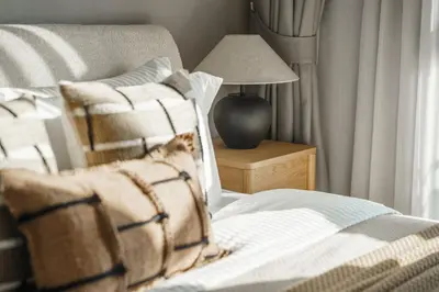 a bedroom with a bed and a chair and a lamp at The Title Legendary Nature Flow in Bang Tao Beach