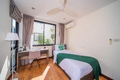 a bedroom with a bed and a desk and a window at Laguna park 5bedroom private pool villa in Laguna Phuket