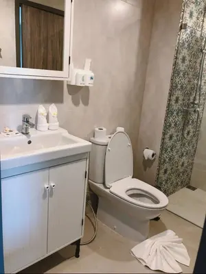 a bathroom with a toilet and a sink at Title - Comfortable 1BR Tropical Retreat in Nai Yang Beach