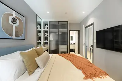 a bedroom with a large bed and a flat screen tv at Bangtao The Title Legendary by Phuket Sabay Rent G201 in Bang Tao Beach