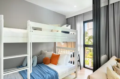 a bedroom with two bunk beds and a couch at Bangtao The Title Legendary by Phuket Sabay Rent G201 in Bang Tao Beach