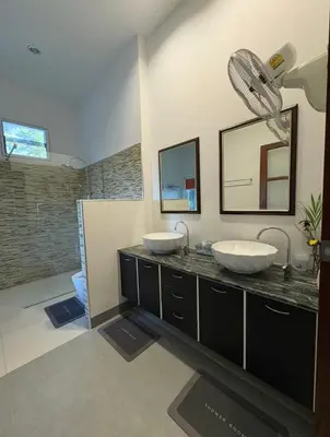 a bathroom with two sinks and a shower at Sunset bay view villa krabi in Ban Khao Thong