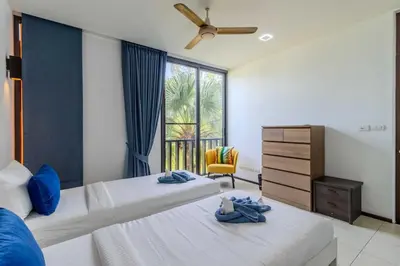 a bedroom with two beds and a window at C254 Condo 2BR Pool View Short Walk to Beach in Thalang