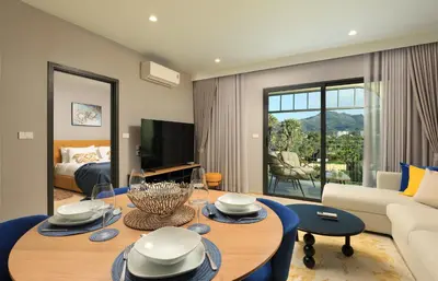 a living room with a table and a couch at 1BR Apartment with Mountain View near Bang-Tao Beach CapitalPro in Bang Tao Beach
