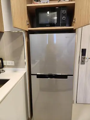 a stainless steel refrigerator in a kitchen with a microwave at Skypark Laguna Apartment with Rooftop Pool at Bang Tao Phuket in Laguna Phuket
