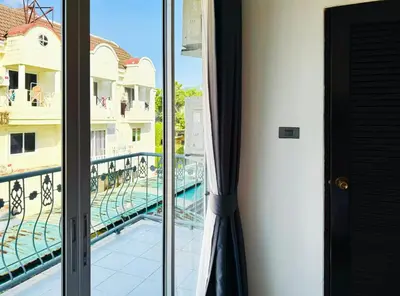 a room with a balcony with a view of a pool at M2 Room For Rent in Patong Beach