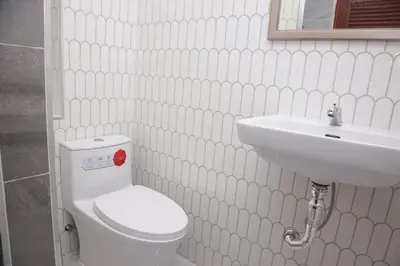 a bathroom with a white toilet and a sink at M2 Room For Rent in Patong Beach