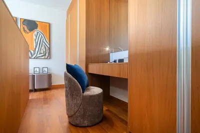 a room with a desk and a blue chair at Luxury Royale Bangtao Pool Villa with maid in Thalang